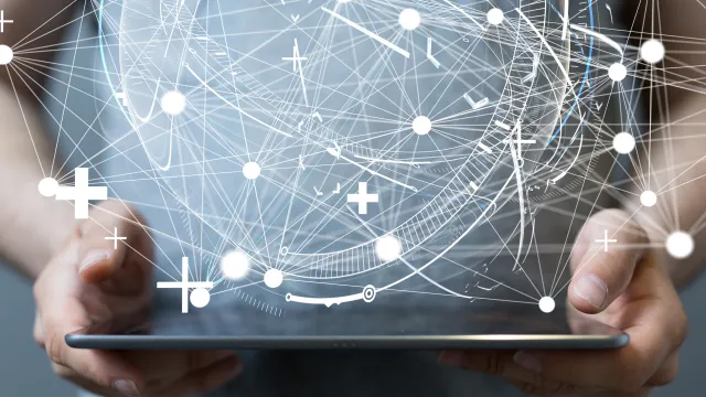 Person holding a tablet, surrounded by digital connections and abstract data flow.
