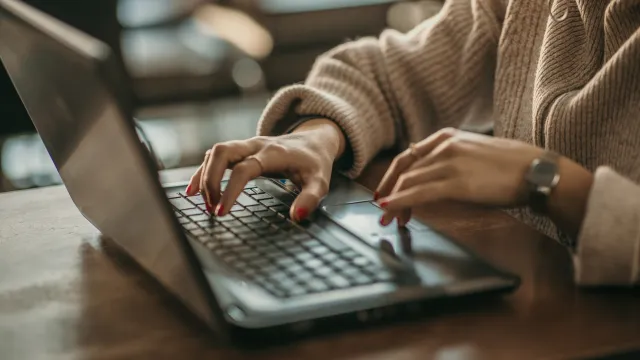 a person typing on a laptop