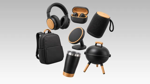 Black and wood-accented wireless headphones, earbuds, speaker, backpack, tumbler, phone stand, and portable grill on gray background