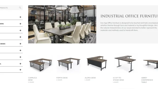 Modern industrial office furniture collection featuring wooden desks with metal frames in a stylish showroom.