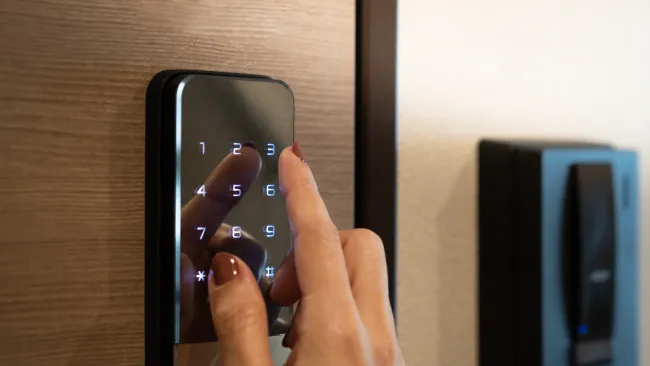 a hand touching a door lock