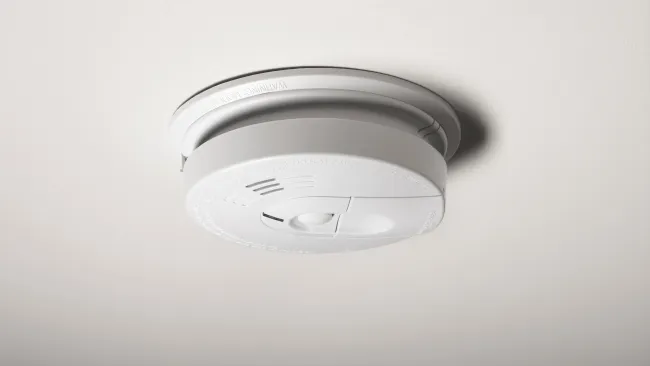 a smoke detector on a white surface
