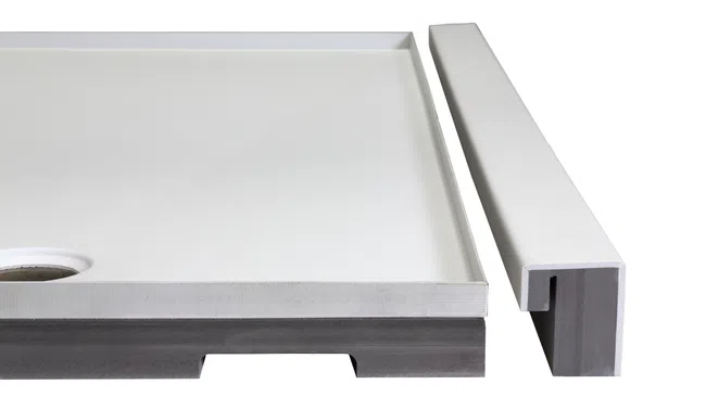 White rectangular shower base with drainage hole and separate matching threshold piece on white background.