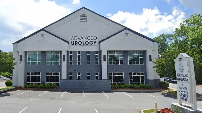 Advanced Urology building with modern architecture and landscaped entrance on a sunny day.