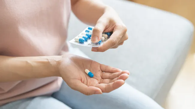 a person holding a pill