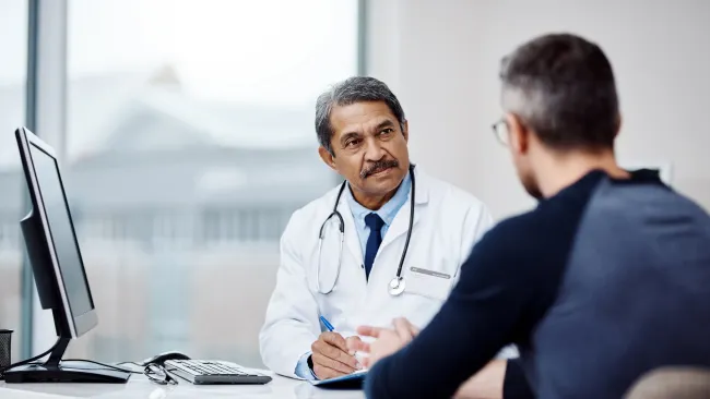 a man and a woman looking at a computer screen