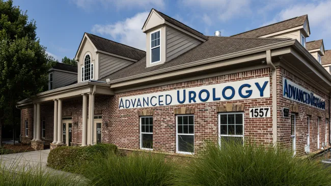 Exterior view of Advanced Urology office building with landscaping and clear signage.