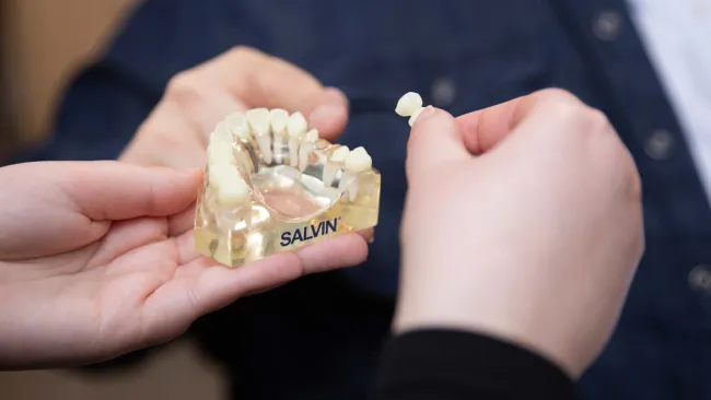 a person holding a bag of popcorn