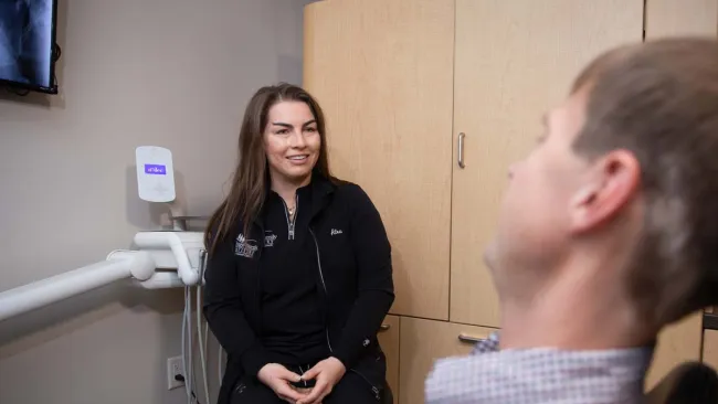 a woman talking to a man