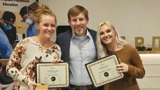 a group of people holding certificates