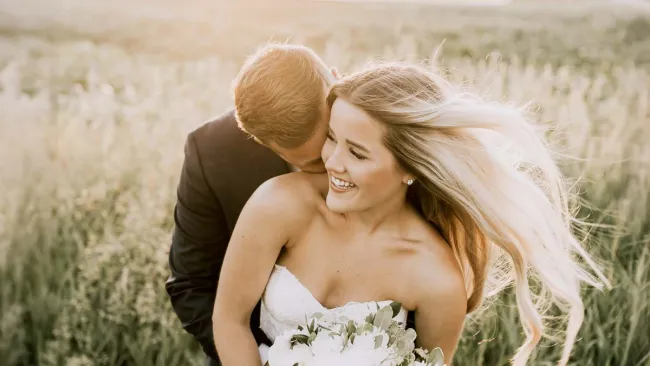 a man and woman kissing in a field