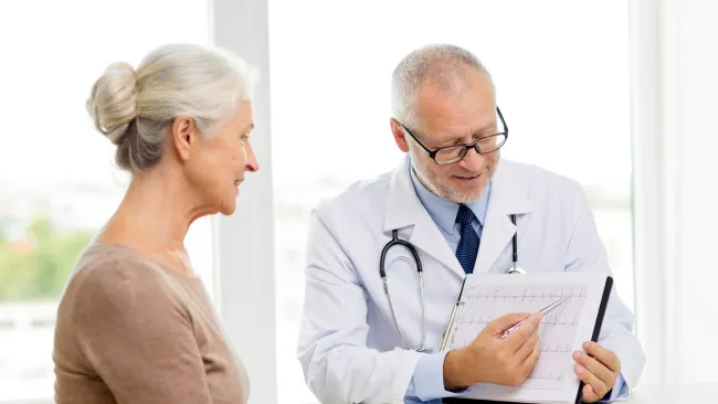 a man and a woman looking at a paper