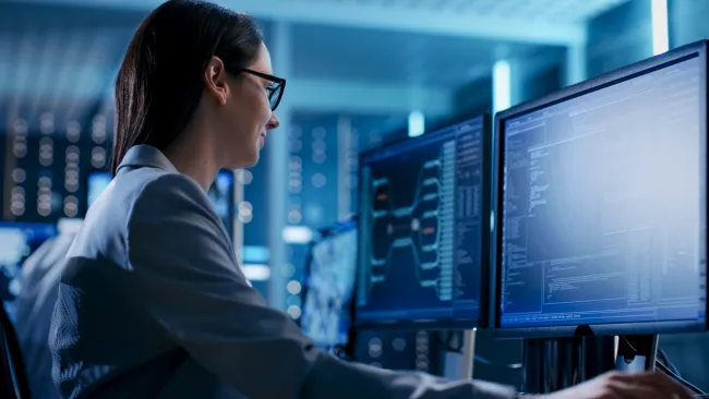 a woman looking at a computer screen