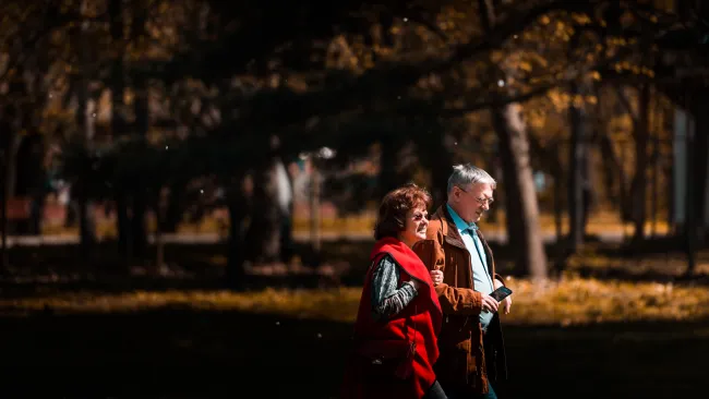 a man and woman standing in a park at night