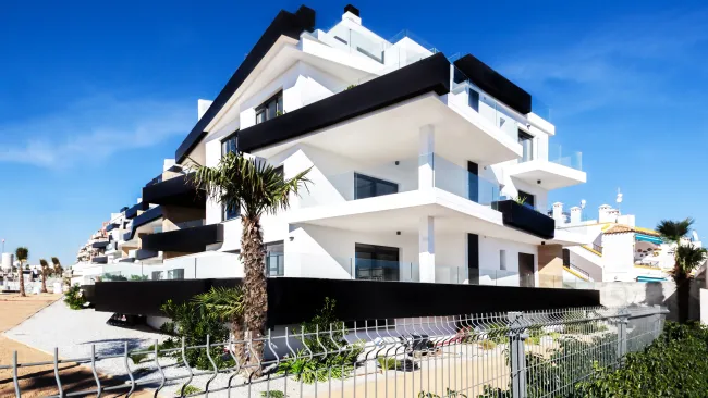 a white house with a fence around it