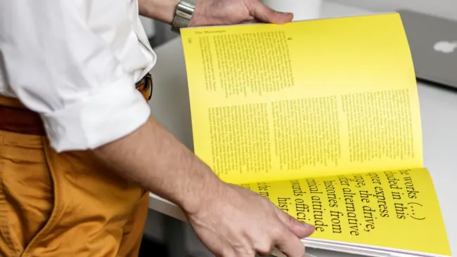 a man holding a yellow box