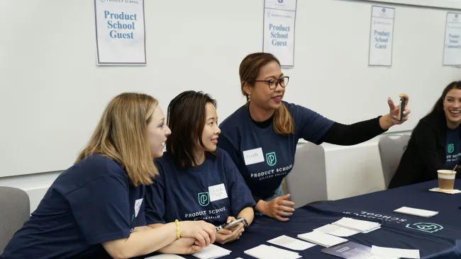 a group of women sitting at a table with papers and papers