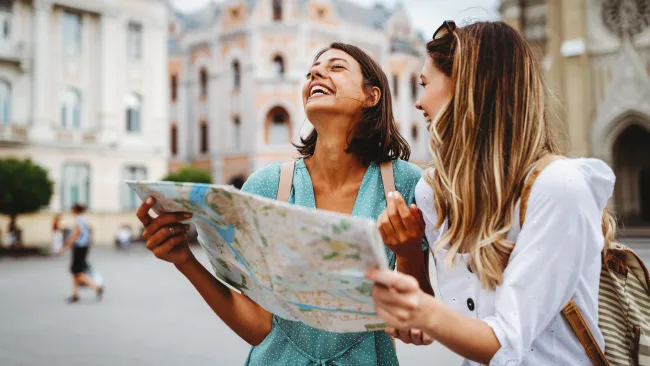 two women looking at a tourist map