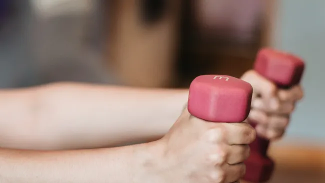 a person's hand holding a pink object
