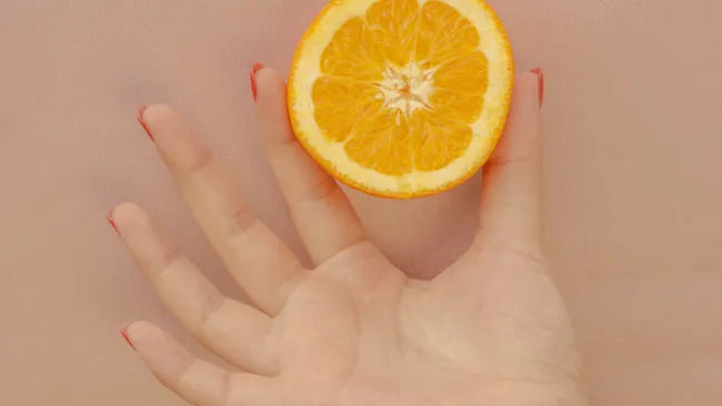 a hand holding a lemon