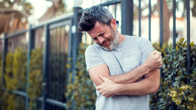 a man holding his elbow