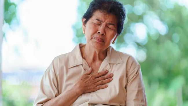 a woman holding her chest