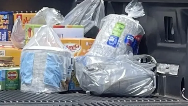 a shelf with bags of food on it
