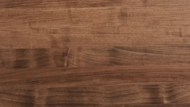Close-up of a dark brown wooden surface with natural grain and texture patterns visible.