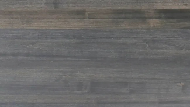 Dark stained wooden texture with natural grain patterns and a smooth matte finish