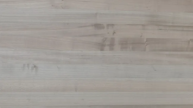 Smooth light gray wooden surface with subtle grain patterns and natural texture