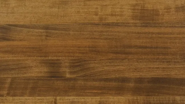 Close-up of a natural wood surface with varied brown tones and visible grain texture