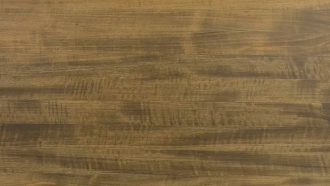 Close-up of smooth wooden surface with natural grain patterns in warm brown tones