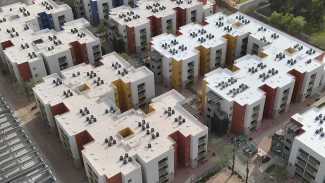 Aerial view of multi-family apartment complex roofing project with TPO white roof systems completed by Mattco Roofing and Construction Texas