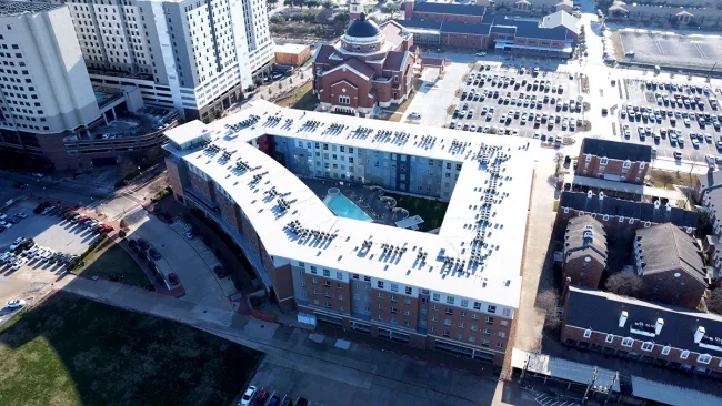 Aerial view of TPO flat roof installation on The Stack Apartments student housing complex in College Station Texas