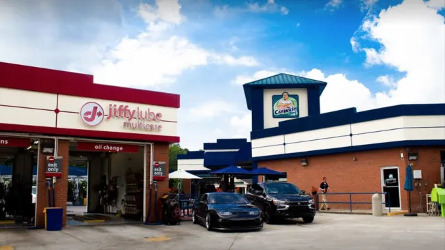 a couple of cars parked outside of a store