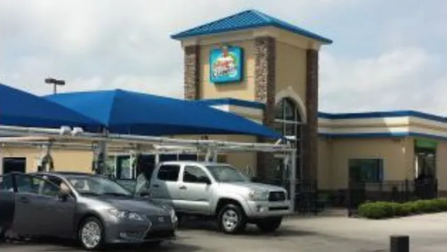 a couple of cars parked outside of a store
