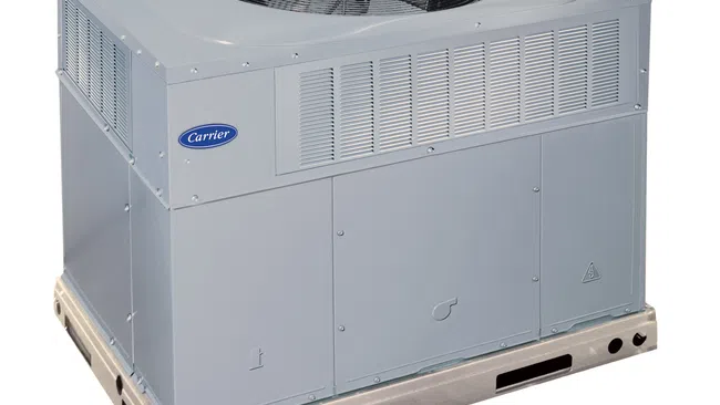 Gray outdoor air conditioning unit with a fan and Carrier branding, designed for residential use.