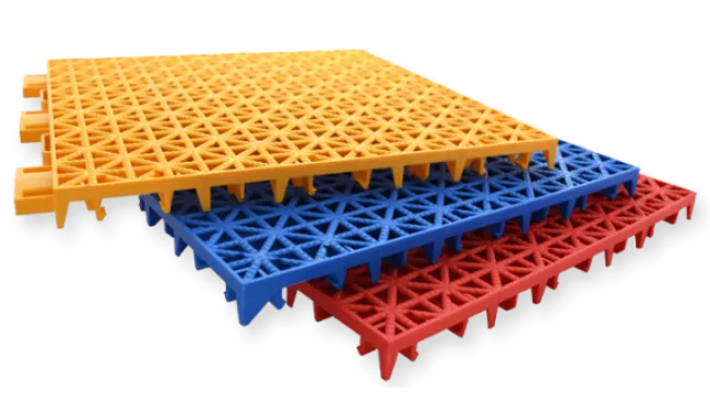 Stacked interlocking yellow, blue, and red plastic floor tiles with a triangular grid pattern.