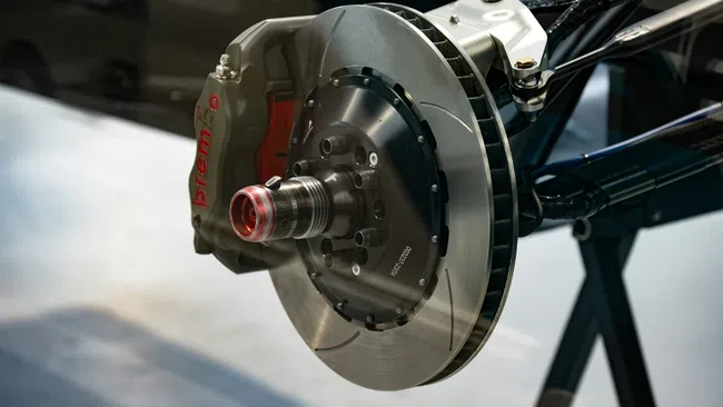 Close-up of a high-performance Brembo brake caliper and rotor assembly on a vehicle suspension system