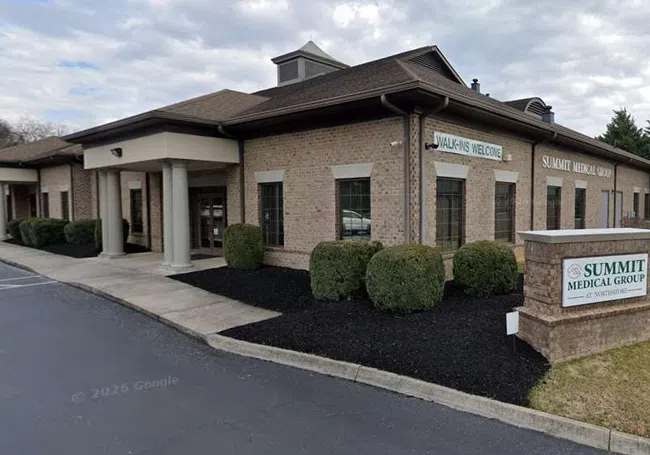 Exterior view of Summit Medical Group building with Walk-Ins Welcome sign and landscaped front area.