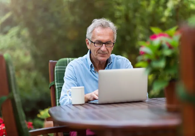 a person standing in front of a computer.