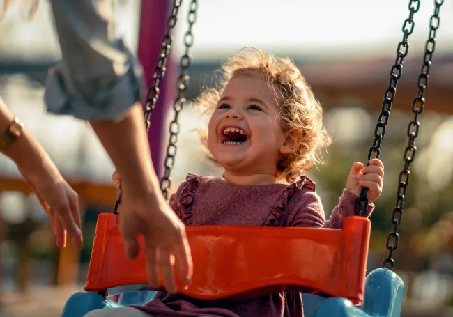 a little girl in a swing