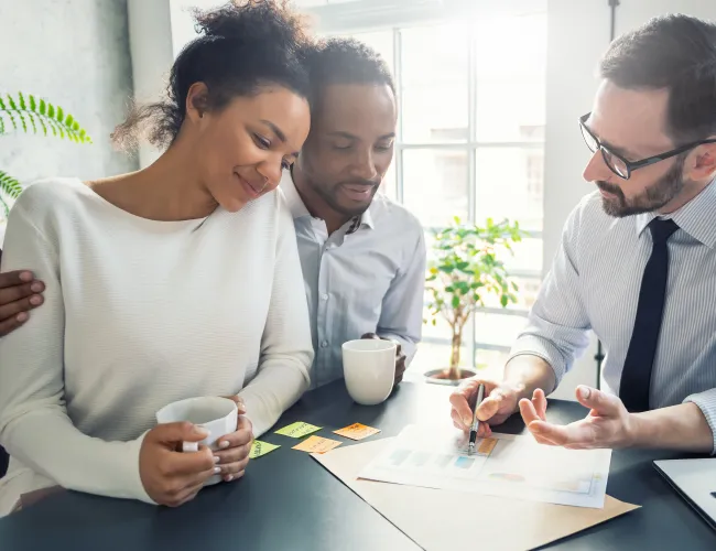 a group of people looking at a paper