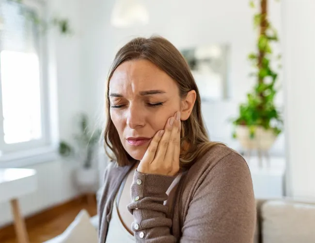 a woman with her hand on her face