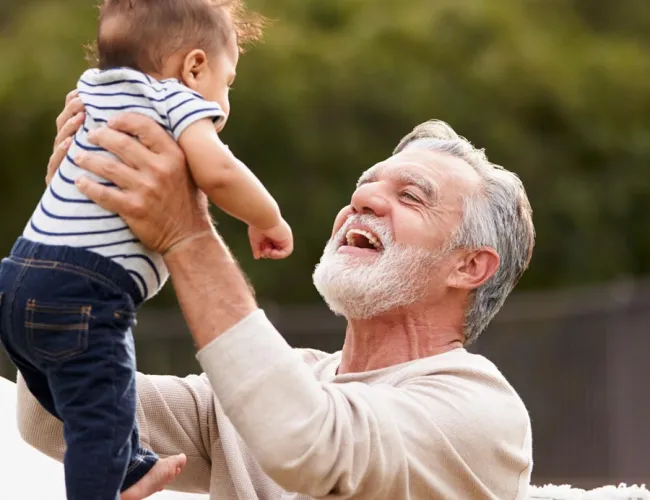 a baby on top of an older man's head