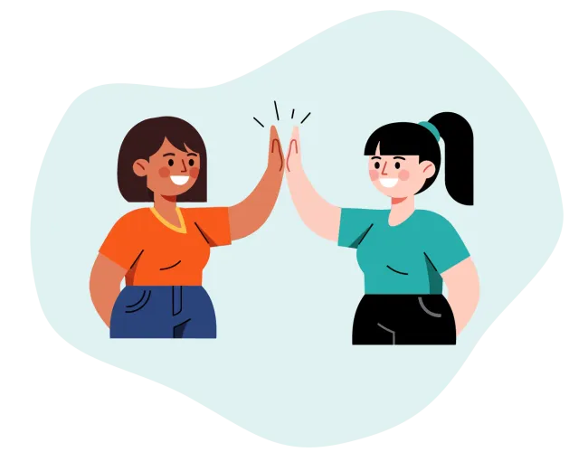 Two women smiling and giving each other a high five in a friendly gesture with casual clothing.