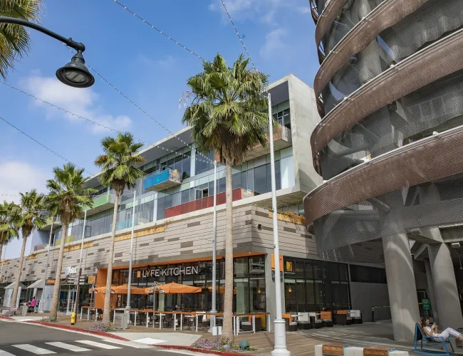 a building with palm trees and a street