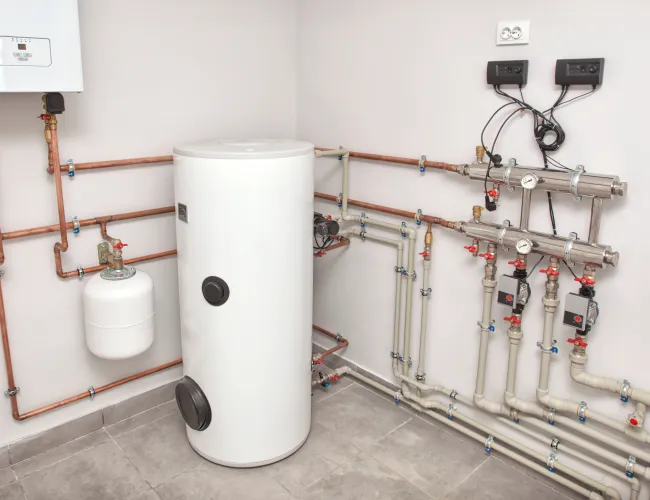 a white cylinder with pipes and tubes