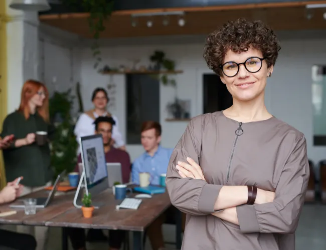 a person standing in front of a table with people sitting at it