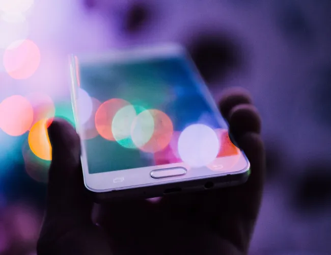 a hand holding a cell phone